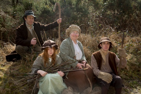 Four people in rural nineteenth century costume